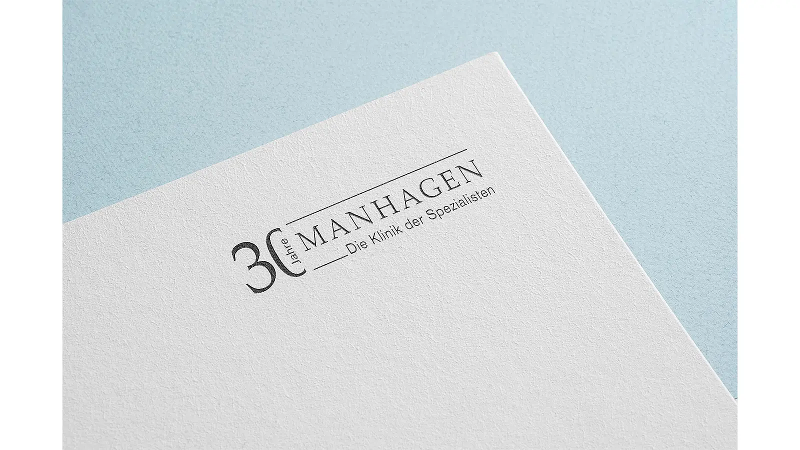 Briefpapier mit Jubiläumslogo der Klinik Manhagen